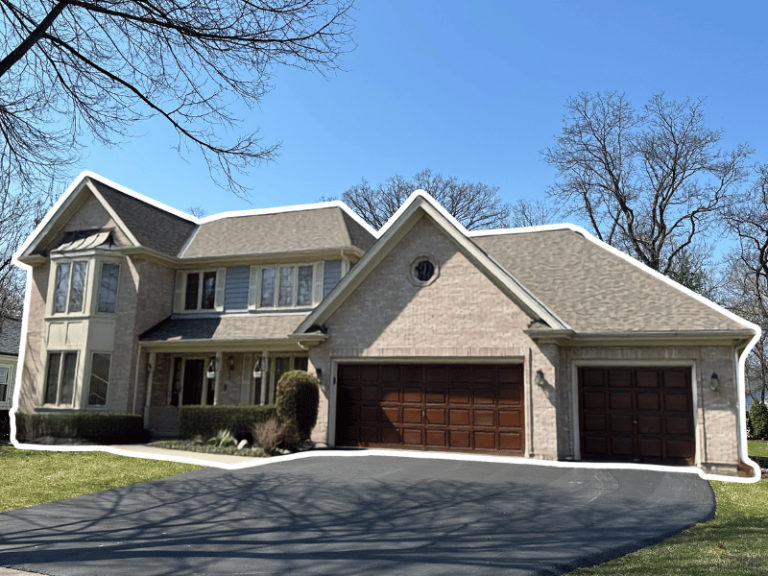 New roof replacement plus freshly stained garage doors to match this charming Naperville home