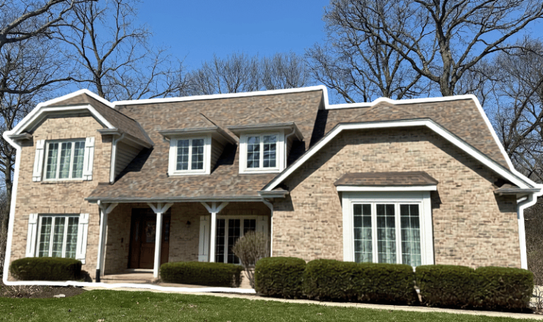 St. Charles home in need of a new roof to replace warped, curling shingles on sloped roof