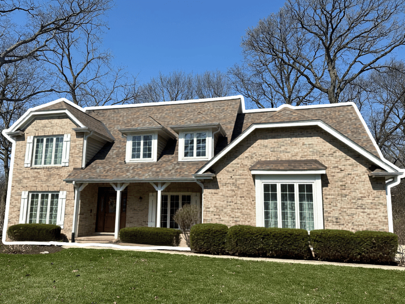 St. Charles home in need of a new roof to replace warped, curling shingles on sloped roof