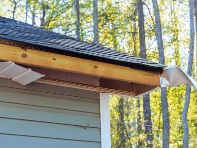 View of roofline with missing gutters and fascia after a high winds damaged this home