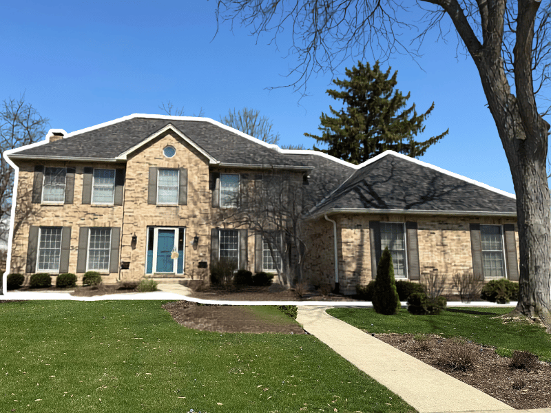 New roof replacement with metal valleys and new gutters on previously storm-damaged Glen Ellyn home